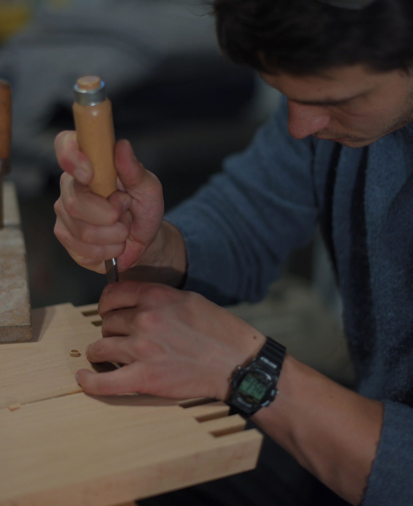 Hand-finishing a solid wood joint in the workshop